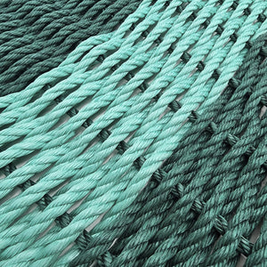 Close-up of green rope with a white background