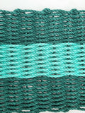 Close-up of green and black rope on a white background