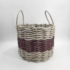 Woven basket with two-tone design on a white background