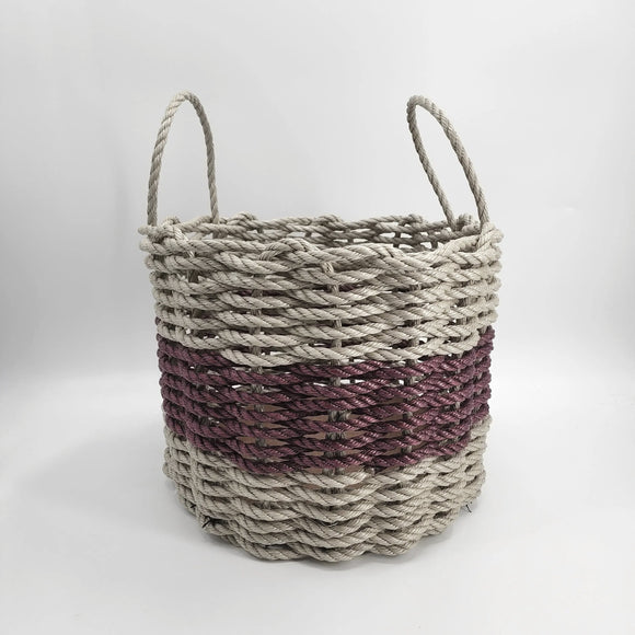 Woven basket with two-tone design on a white background