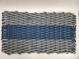 Woven mat with blue and beige pattern on a white background