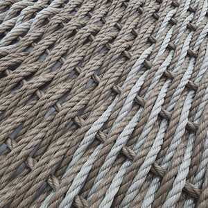 Close-up of a woven mat made from natural fibers on a light background