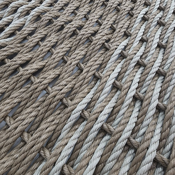 Close-up of a woven mat made from natural fibers on a light background