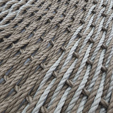 Close-up of a woven mat made from natural fibers on a light background