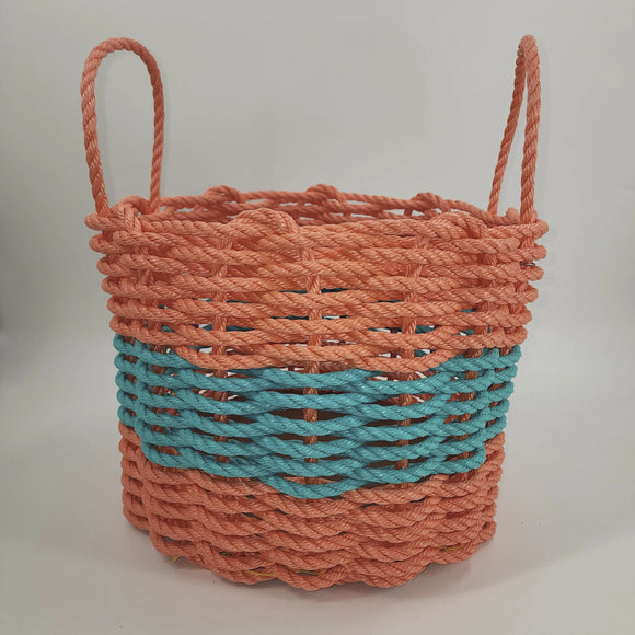Woven basket with orange top and teal bottom on a light gray background