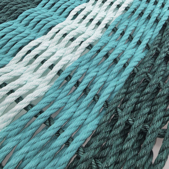Close-up of teal and green ropes with a gradient effect.