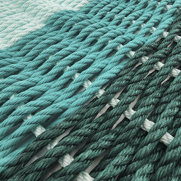 Close-up of teal and white rope on a light gray background