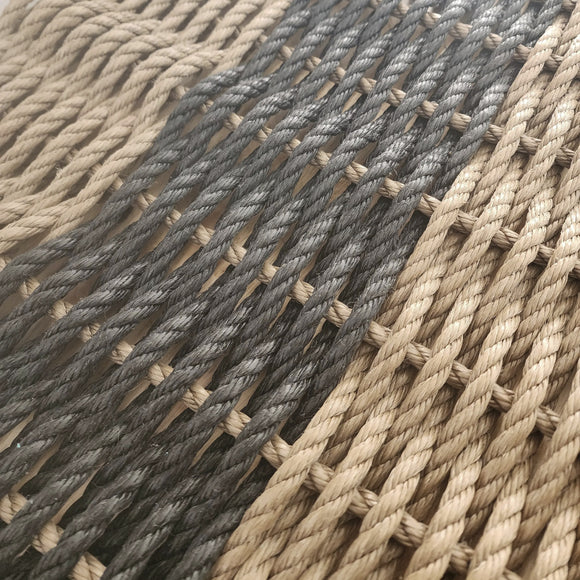 Close-up of woven rope with natural and gray tones.