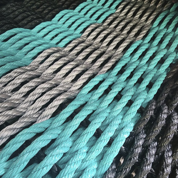 Close-up of teal and gray ropes intertwined.