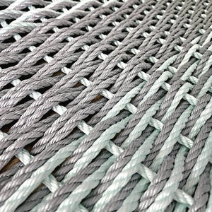 Close-up of woven gray and green rope texture