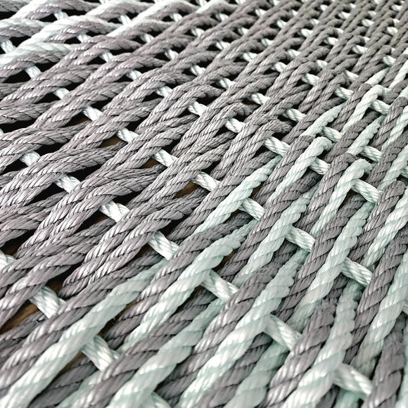 Close-up of woven gray and green rope texture