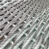 Close-up of woven gray and green rope texture