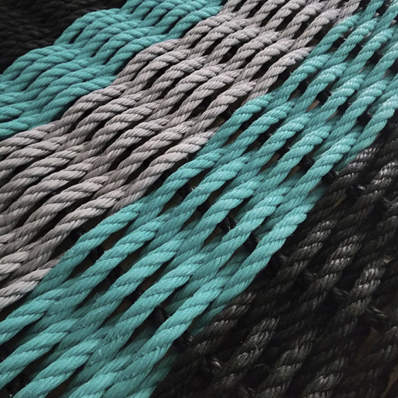 Close-up of teal, gray, and black ropes.