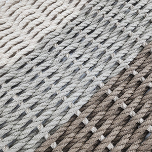 Close-up of woven rope mat with natural and gray tones