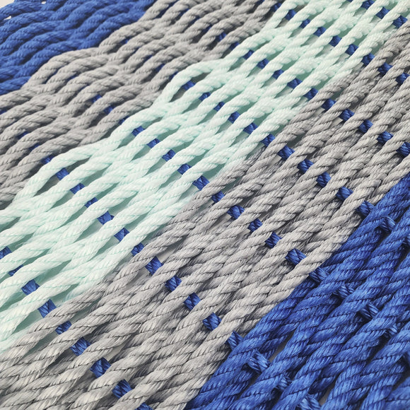 Close-up of blue, gray, and green braided ropes.