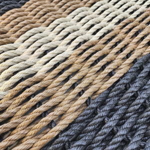 Close-up of braided rope in various colors including black, brown, and beige.
