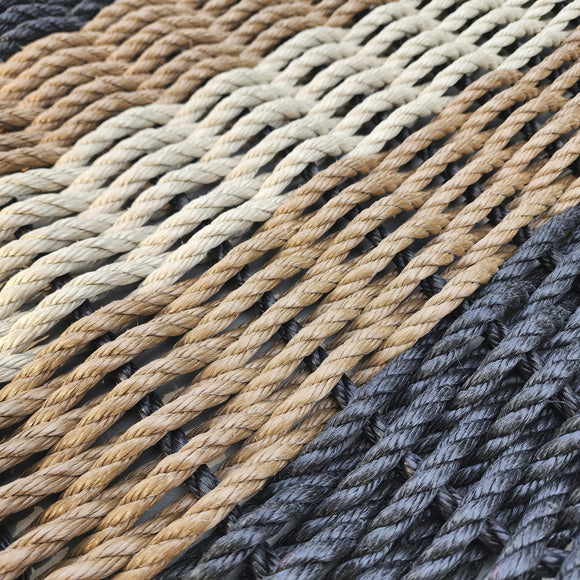 Close-up of braided rope in various colors including black, brown, and beige.