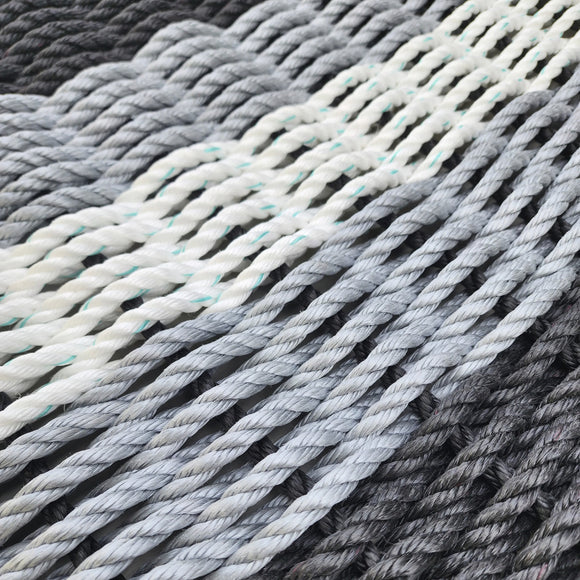 Close-up of twisted yarn in various shades of gray and white.