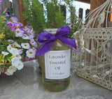 Bottle of lavender essential oil with a purple bow, surrounded by flowers and plants.