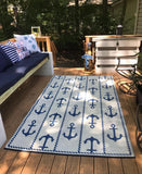 Nautical-themed rug with anchor pattern on a wooden deck