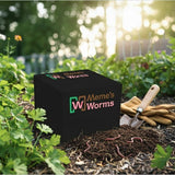 Meme's Worms product in a garden setting with worms on soil and gardening tools.