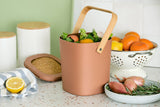 Astrik Compost Bin with fresh produce on a kitchen counter