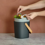 Person using a Astrik Compost Starter Bundle with a brown background