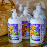 Appalachian Goat soap bottles with colorful labels on a wooden surface.