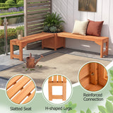 L-shaped outdoor wooden bench set with a slatted seat, shown in a patio garden setting. The image includes two circular detail callouts highlighting the slatted seat construction and reinforced corner connection, with text labels 'Slatted Seat', 'H-shaped Legs', and 'Reinforced Connection'.