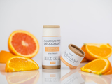 Aluminum-free deodorant with oranges on a reflective surface