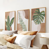 Bedroom with framed 3 Piece Terracotta Boho Wall Art. Green Tropical Leaves on the wall