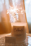 Candle labeled 'Celebrate' with a sparkler in the background
