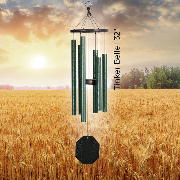 Rustic Rhythms Wind Chimes with 'Tinker Belle' and '32”' text against a sunset over a field background