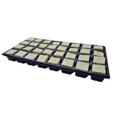 Black tray with multiple square compartments containing beige blocks on a white background
