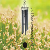 Whispers in the Wind Series Wind Chime labeled 'Spring Meadow Song' against a blurred natural background