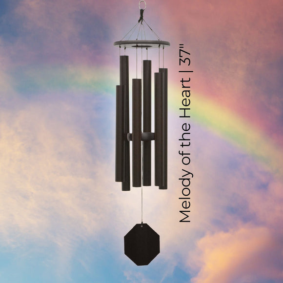 Biblical Bells Series Wind Chime with 'Melody of the Heart' text against a colorful sky background