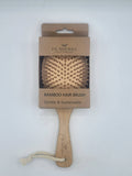 Bamboo hair brush with packaging on a white background