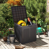 Black garden storage box with tools and a hose on a wooden deck