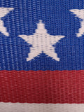 Close-up of a woven fabric with a star pattern on a blue, red, and white background
