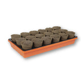 Seed starting tray with small CowPots® #3 Round pots filled with soil on a white background 