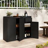 A black wicker-textured outdoor storage cabinet with two doors open, showing shelves and wine bottles inside, placed on a light wood deck against a white wall with a railing behind it.