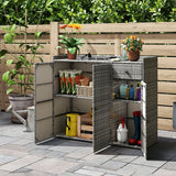 Gray wicker-style outdoor storage cabinet with open doors, shown on a paved patio in front of a wooden fence and garden plants. The cabinet is stocked with gardening tools and pots.