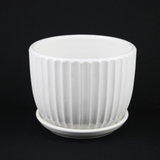 White Ceramic Planter Pot with Vertical Fluted Design & Matching Saucerson a black background