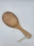 Wooden brush with a handle on a white background