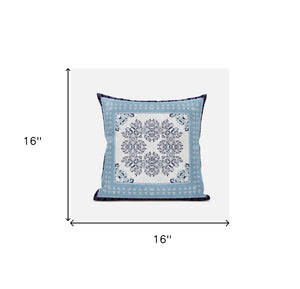 Decorative pillow with a blue border and white center pattern on a light blue background