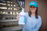 Person holding a bottle of 'Sea Salt' product in an indoor setting