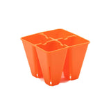 Orange plastic seedling tray on a white background 4 Cell Plug Tray Inserts