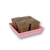 Pink tray with six brown seedling pots on a white background CowPots® #4 Square