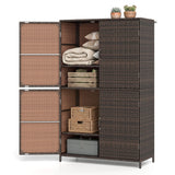 A three-tier wicker storage cabinet with dark brown woven sides and doors, tan woven front panels, and open shelves displaying folded blankets, pillows, baskets, and a storage box, set against a plain white background.