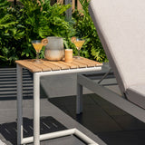 Small outdoor table with two cocktails and a lantern on a patio setting